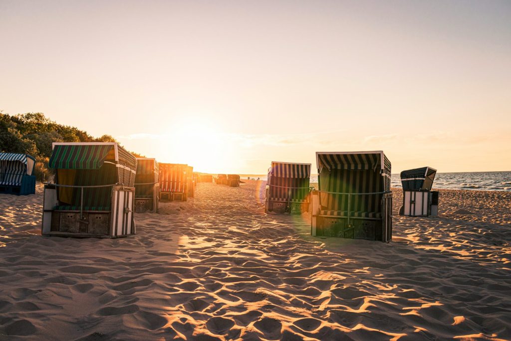 brown wooden houses on brown sand during daytime